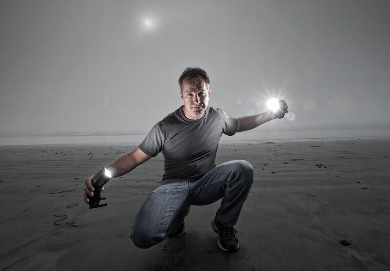 photographer holding two flash guns