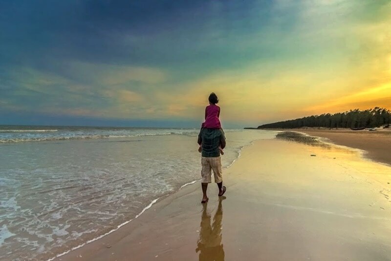 father and daughter on beach