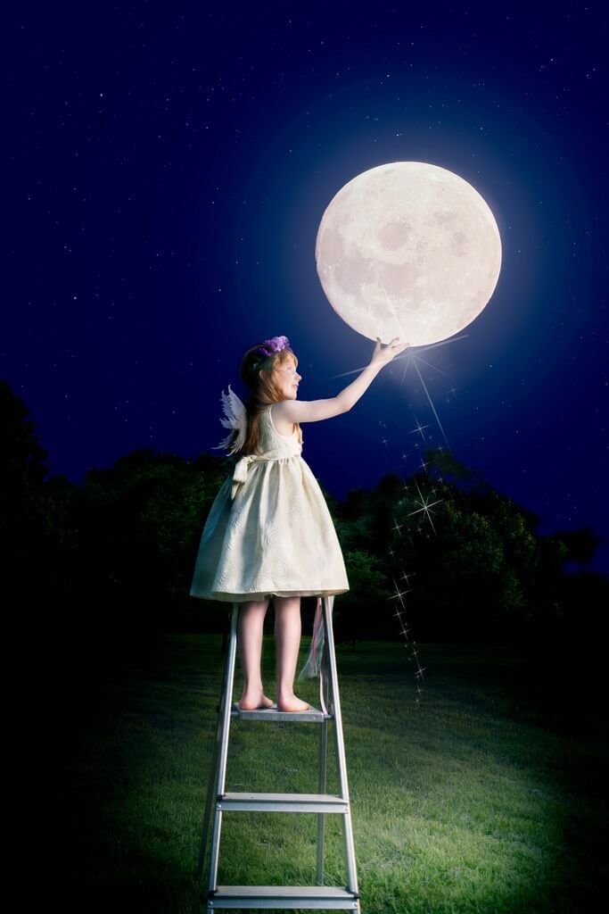 girl touching moon