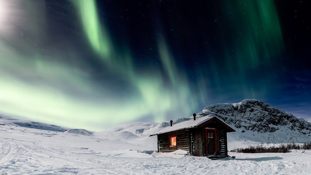 Hille Thomasson - wooden cabin with northern lights