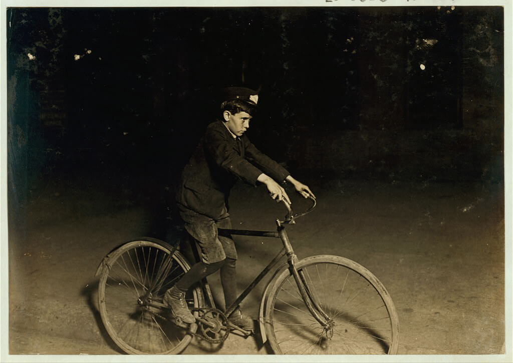 Lewis Wickes Hine - messenger boy on bike at night