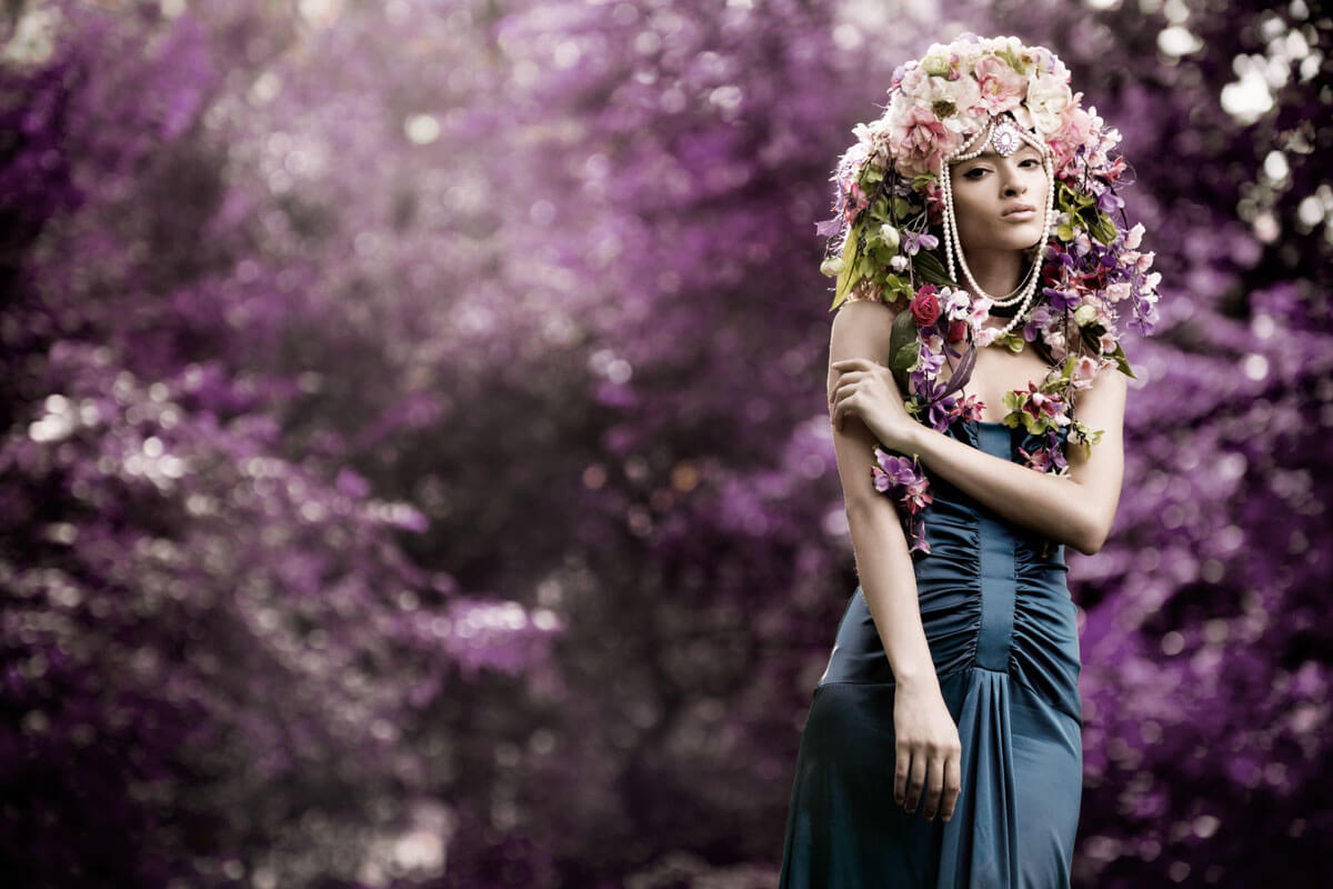 portrait of a floral goddess in front of more flowers